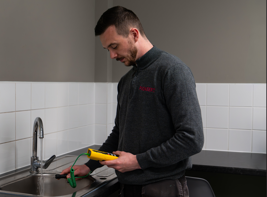 Legionella water temperature testing by Pioneer FM engineer in commercial building UK