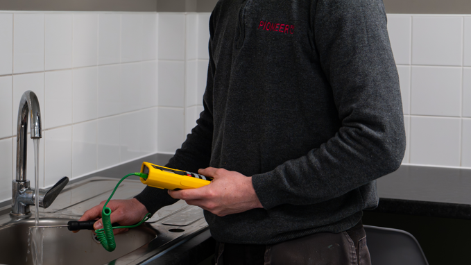 Legionella water temperature testing by Pioneer FM engineer in commercial building UK