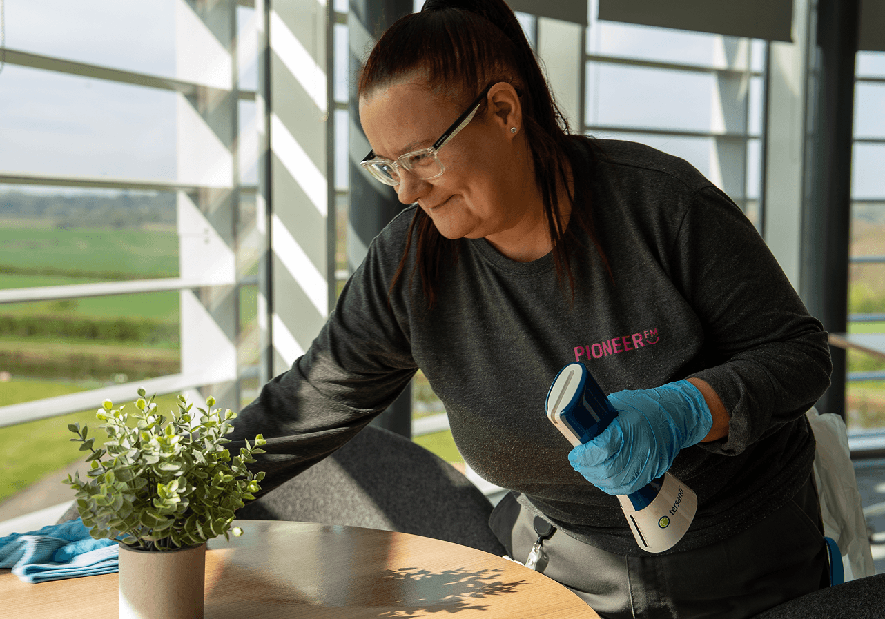 Commercial cleaning operative sanitising office space using chemical-free cleaning system