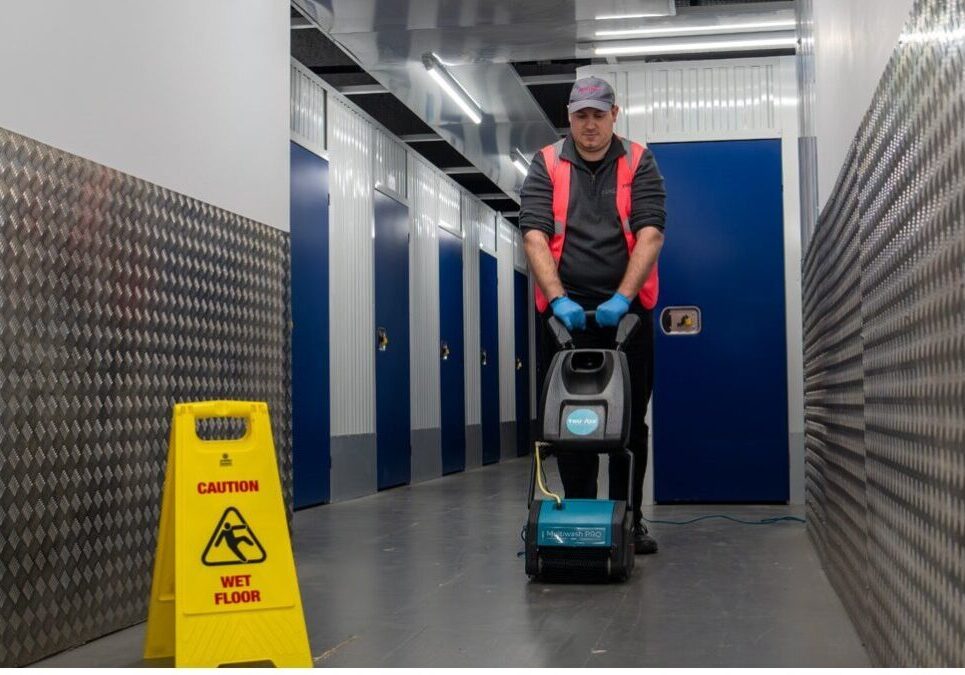 Industrial floor cleaning using a scrubber machine in a warehouse environment